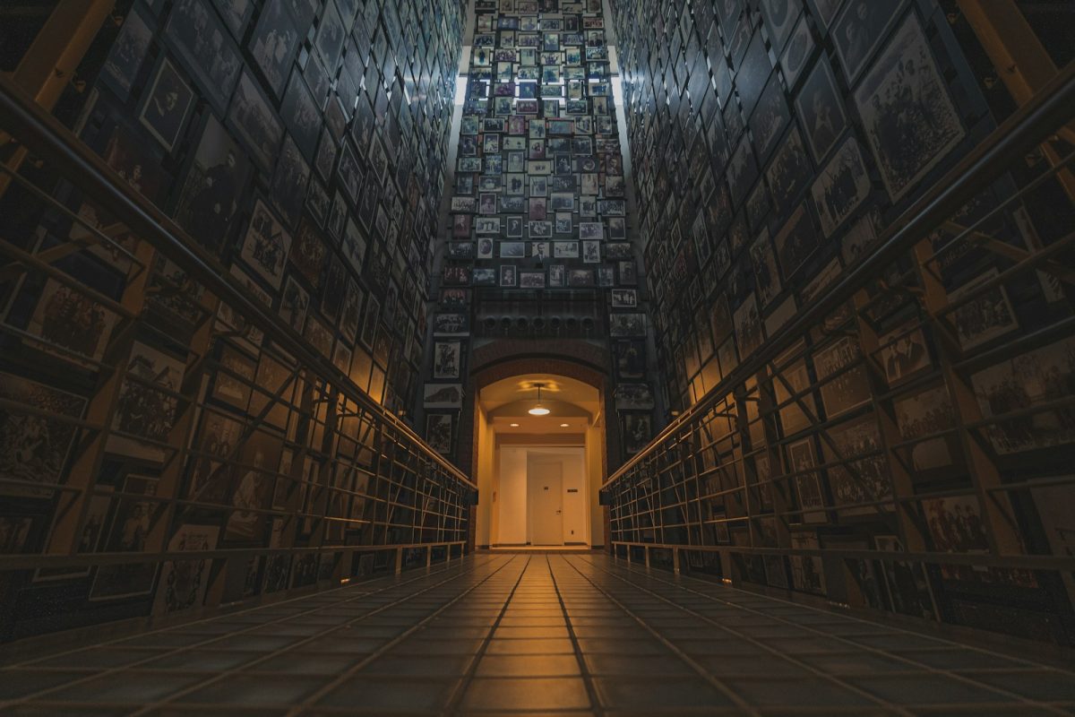 a very long hallway with a bunch of pictures on the wall