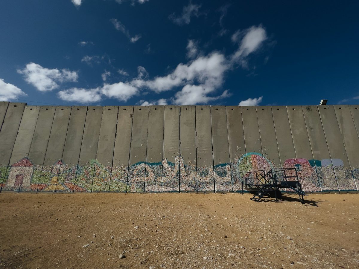 a wall with graffiti on it and a bench in front of it
