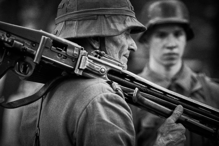 Black and white photo of soldiers with rifles in historical attire