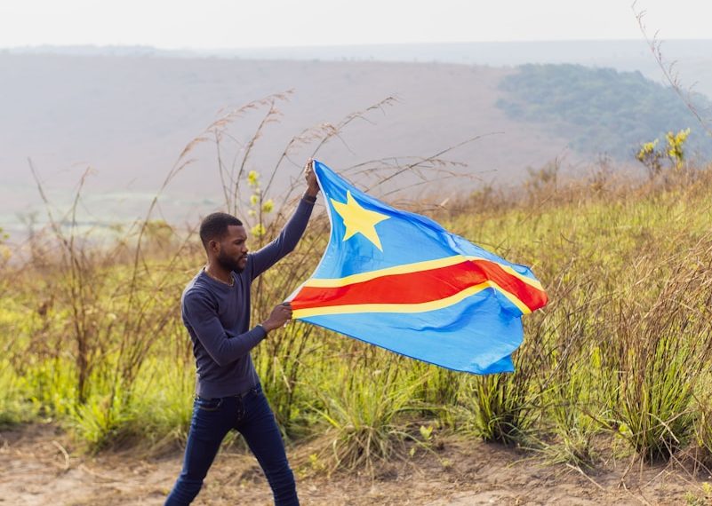 A man holding a flag in a field