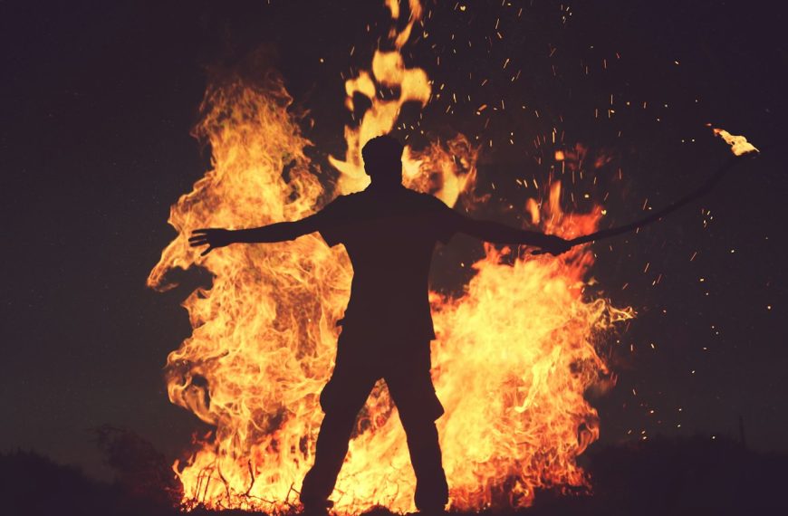 person standing in front of fire during night time