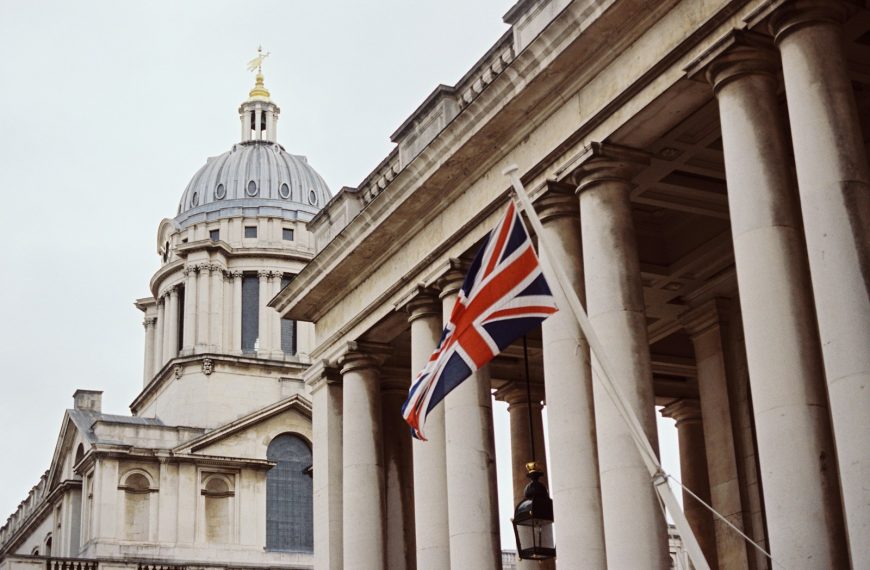 a british flag flying in front of a building