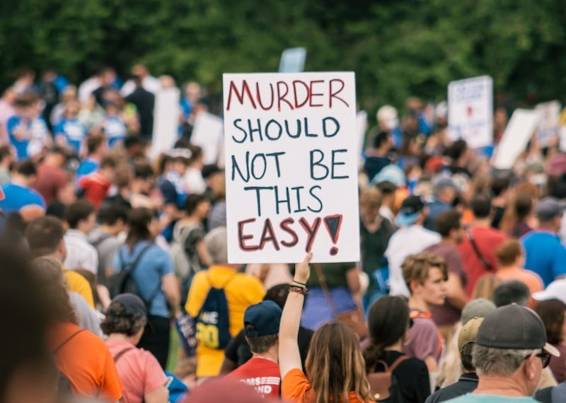 a crowd of people holding signs