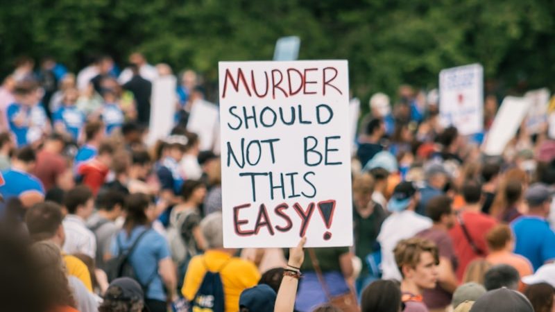 a crowd of people holding signs