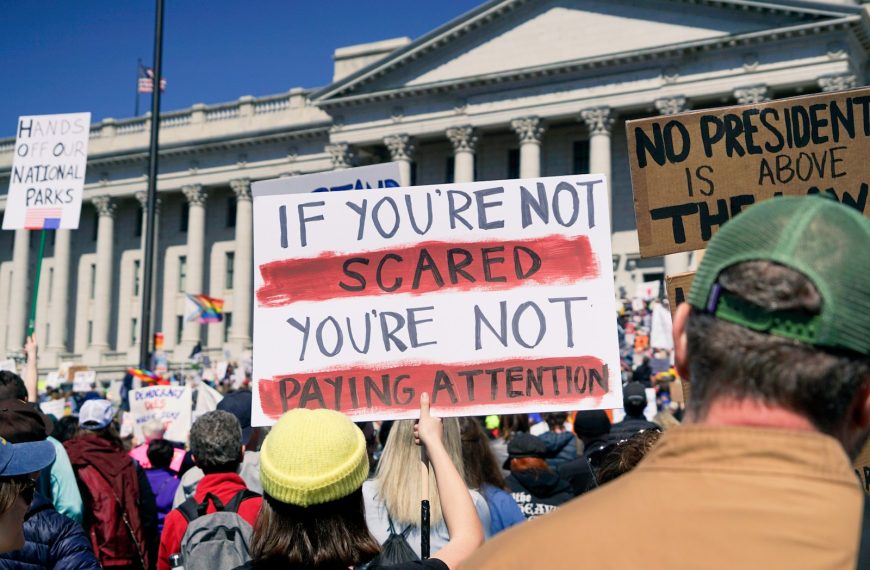 Protestors hold signs during a political demonstration.