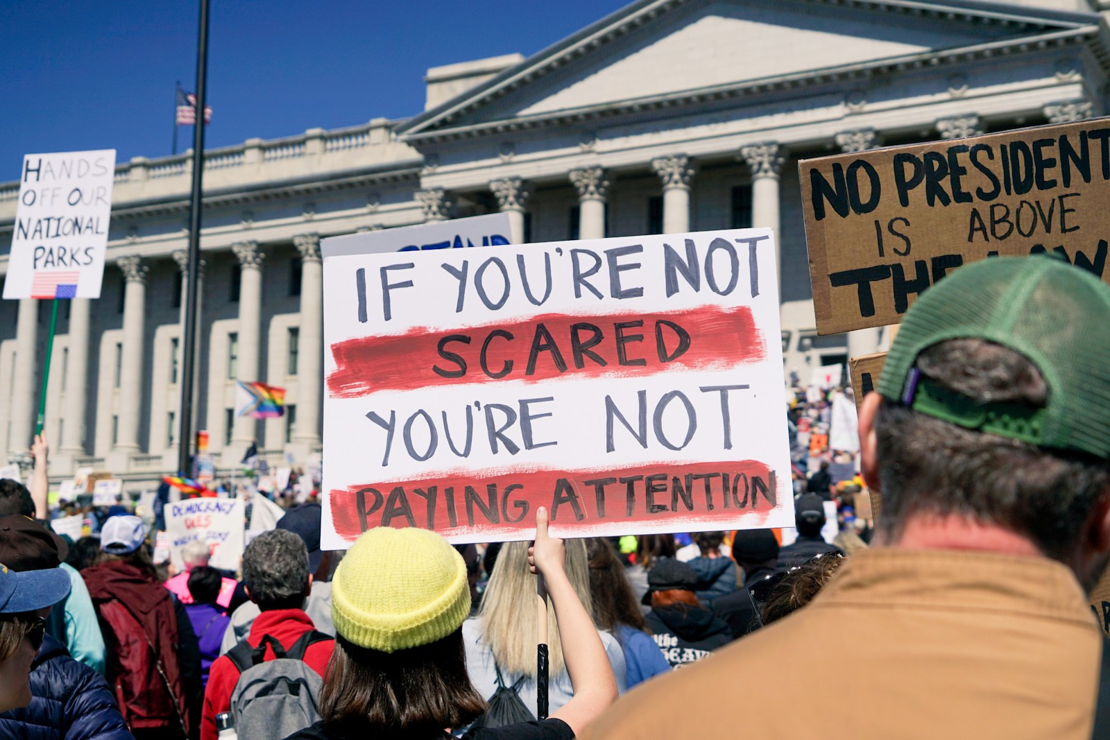 Protestors hold signs during a political demonstration.