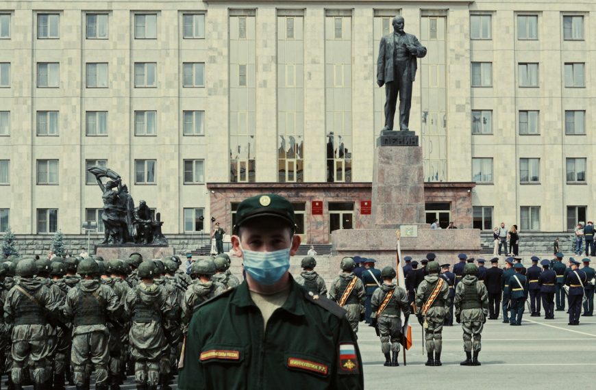 soldiers in black uniform standing near gray concrete building during daytime