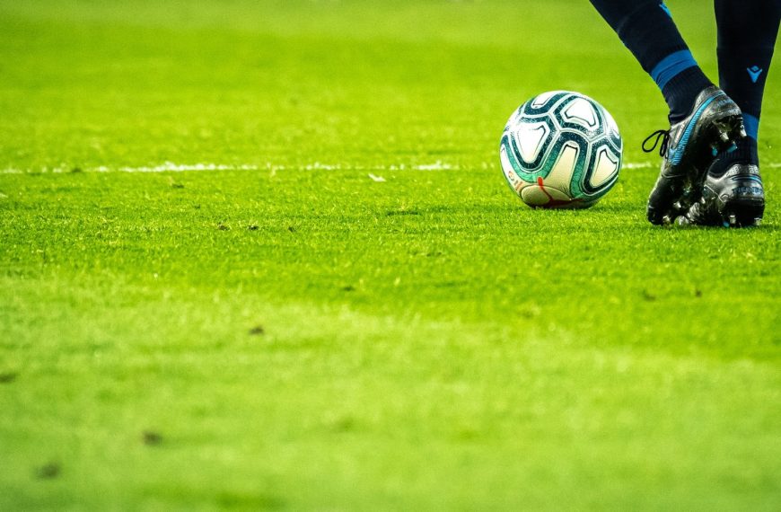 man playing soccer game on field
